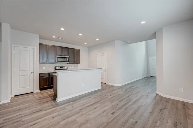 a view of kitchen with microwave and cabinets
