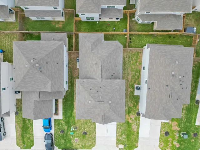 an aerial view of residential houses with outdoor space