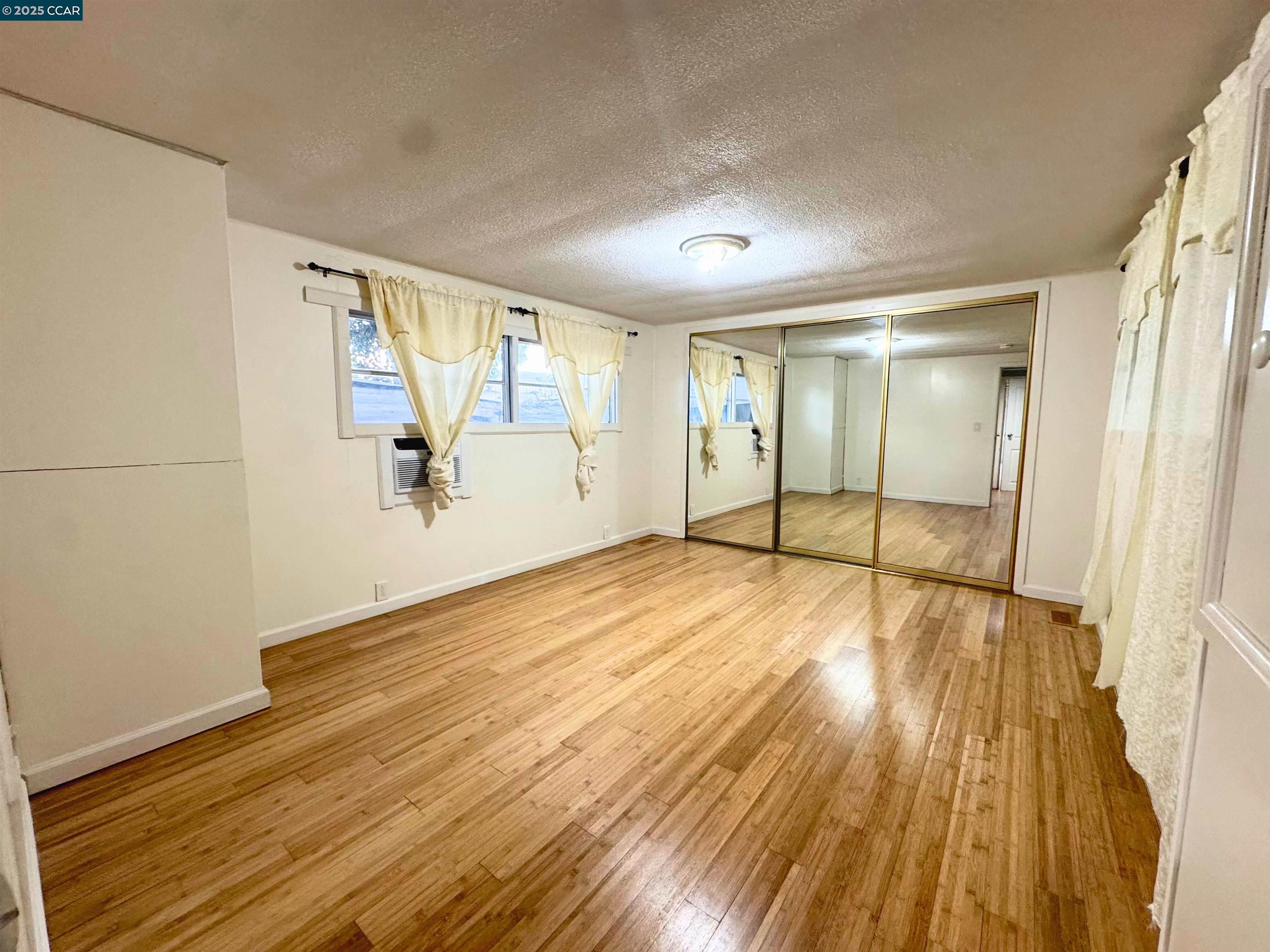 55 Pacifica Avenue, Unit 110 Bay Point, CA 94565 - Photo 11 of 20 wooden floor in an empty room with a window