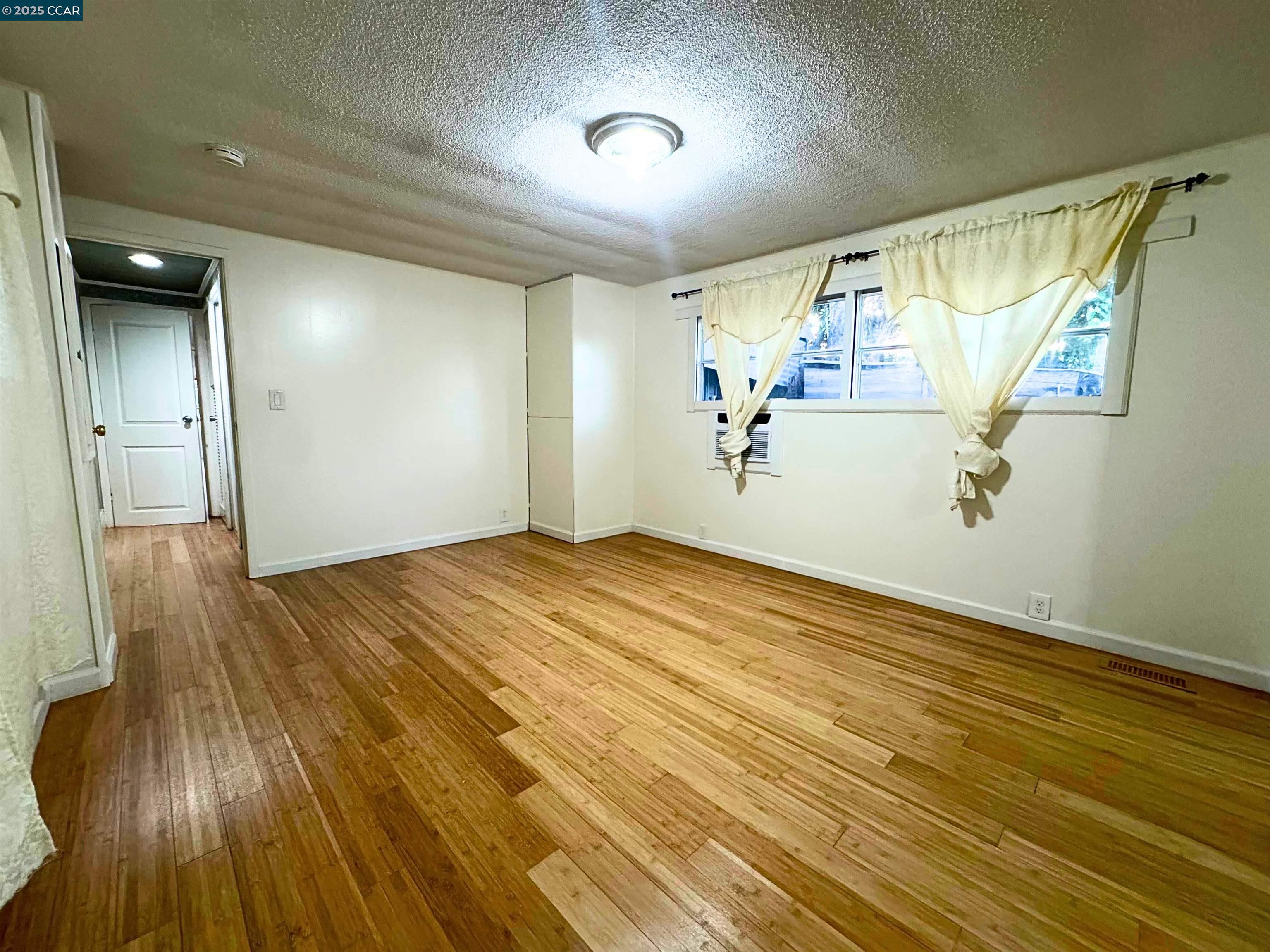 55 Pacifica Avenue, Unit 110 Bay Point, CA 94565 - Photo 12 of 20 a view of empty room with wooden floor