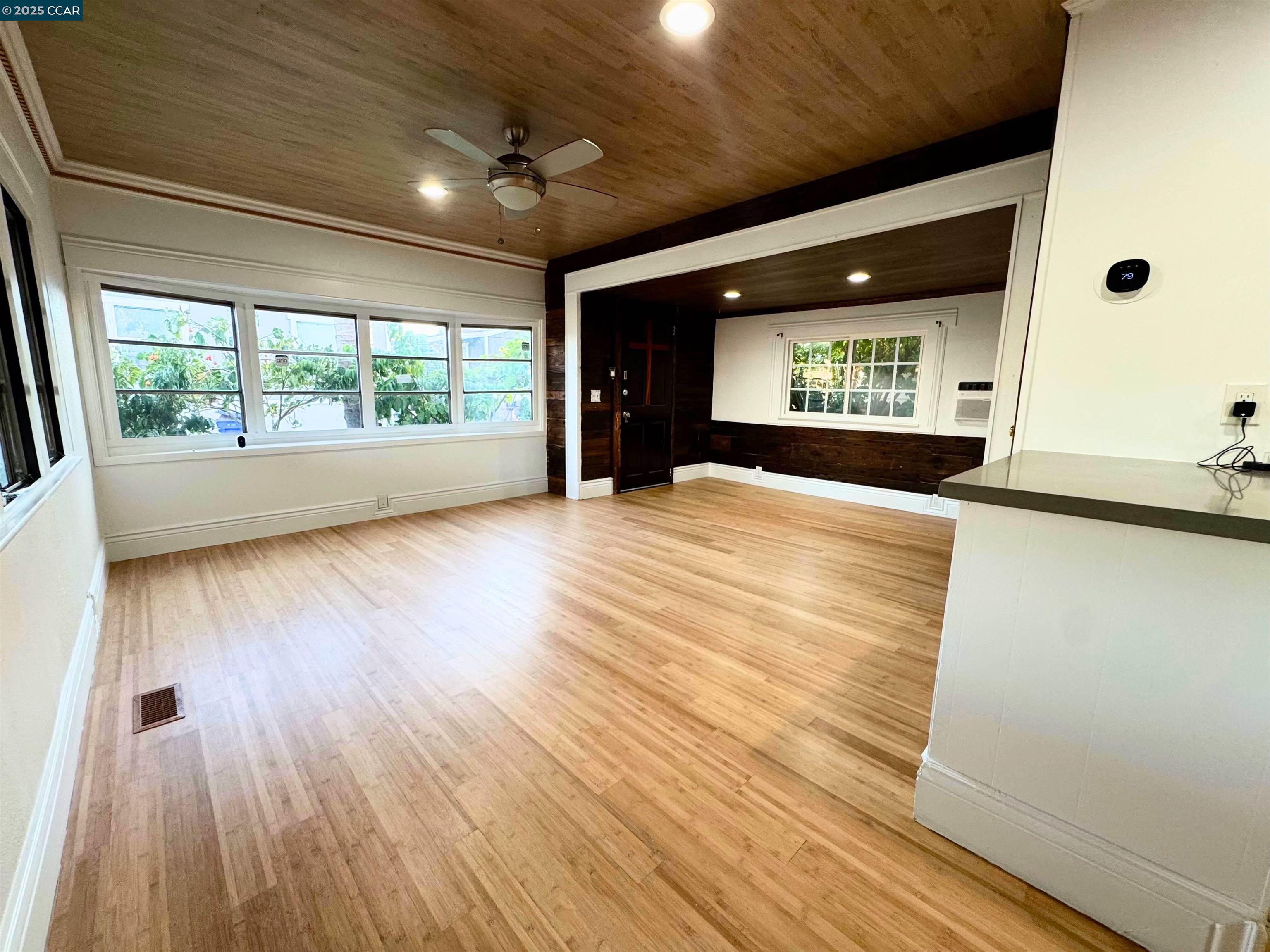 55 Pacifica Avenue, Unit 110 Bay Point, CA 94565 - Photo 6 of 20 a view of an empty room with wooden floor and a window