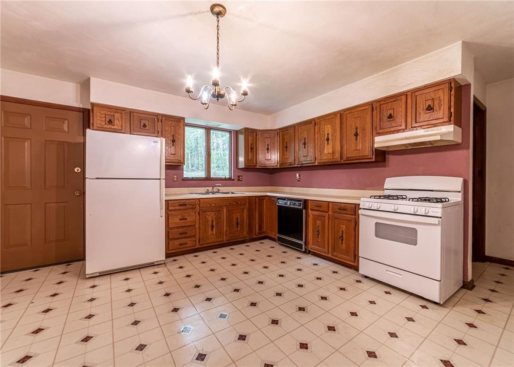 144 Cooper Road Cabot, PA 16023 - Photo 12 of 25 a kitchen with stainless steel appliances a stove a sink and a refrigerator