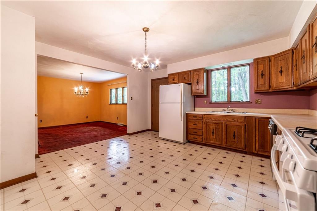 144 Cooper Road Cabot, PA 16023 - Photo 13 of 25 a kitchen with stainless steel appliances a refrigerator and a stove top oven