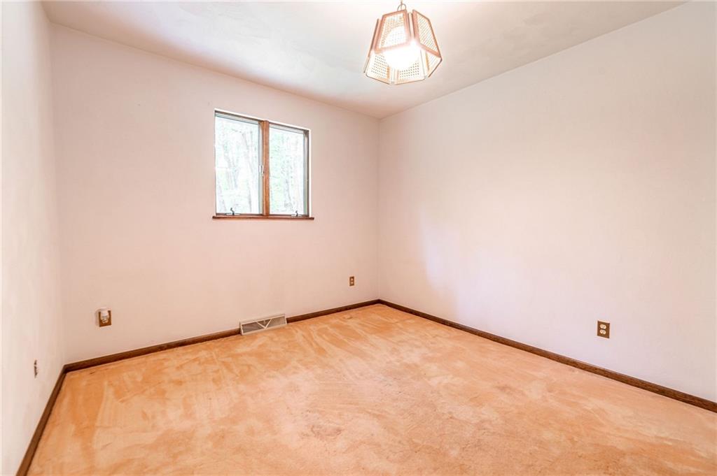 144 Cooper Road Cabot, PA 16023 - Photo 17 of 25 an empty room with a chandelier fan and window