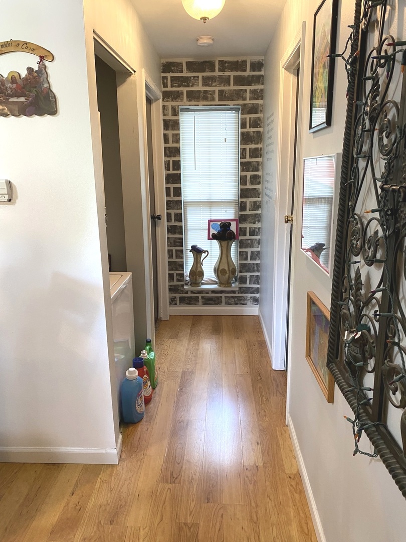 2038 North Rand Road, Unit 212 Palatine, IL 60074 - Photo 20 of 27 a view of a hallway with wooden floor and a living room
