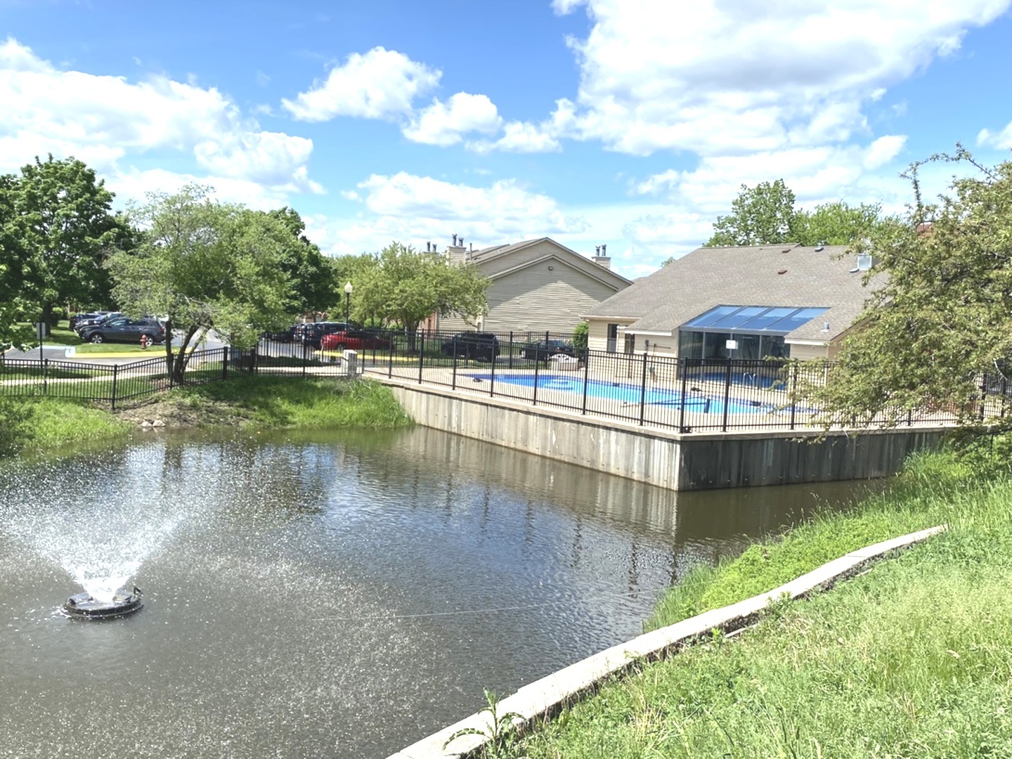 2038 North Rand Road, Unit 212 Palatine, IL 60074 - Photo 25 of 27 a view of a lake with a yard and large trees