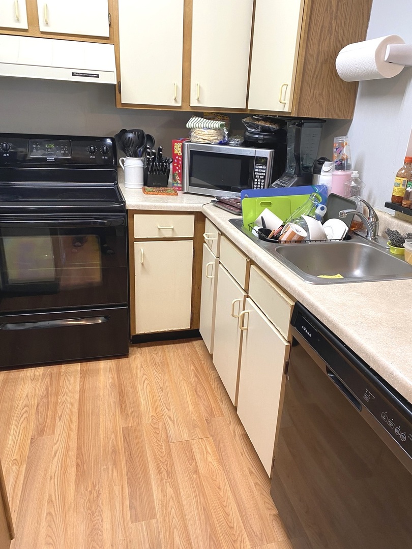 2038 North Rand Road, Unit 212 Palatine, IL 60074 - Photo 8 of 27 a kitchen with a sink a stove and cabinets