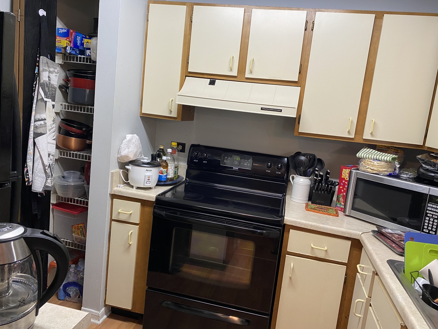 2038 North Rand Road, Unit 212 Palatine, IL 60074 - Photo 9 of 27 a kitchen with a stove and a microwave