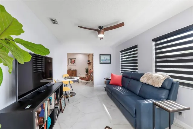 a living room with furniture a rug and a window