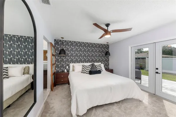 a bedroom with a large bed and a couch