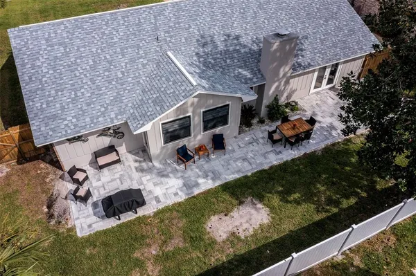 a aerial view of a house with a yard and lake view