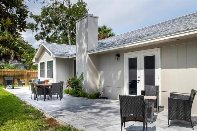 a view of a house with backyard and sitting area