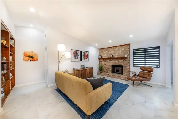 a living room with furniture and a fireplace