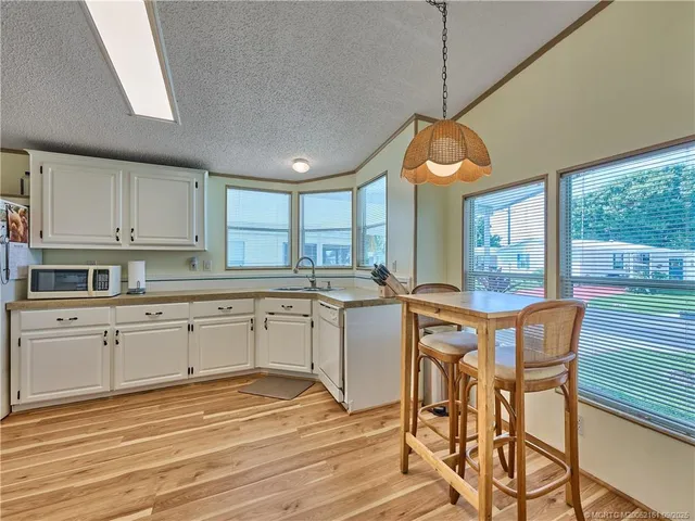 a kitchen with stainless steel appliances granite countertop a stove a sink dishwasher and a refrigerator