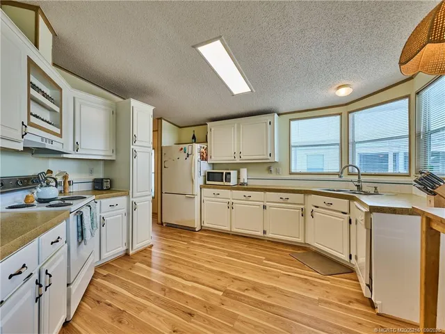 a kitchen with stainless steel appliances granite countertop a stove and a refrigerator