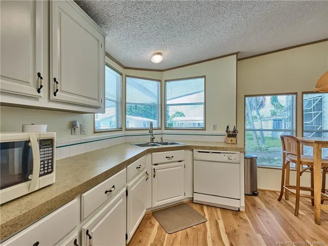 a kitchen with stainless steel appliances a refrigerator sink and cabinets