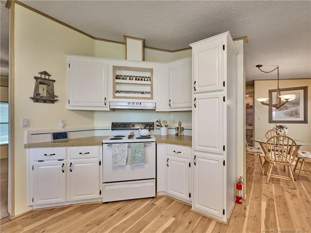 a view of a dining table chairs and chandelier