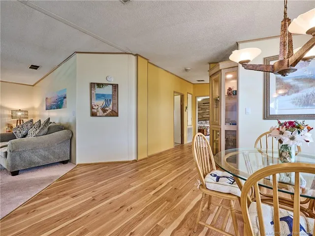 a spacious bedroom with a bed and a chandelier