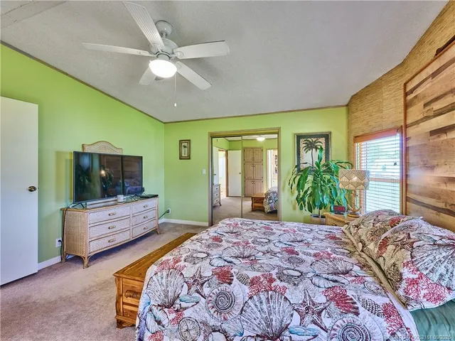 a spacious bathroom with a granite countertop sink and a mirror