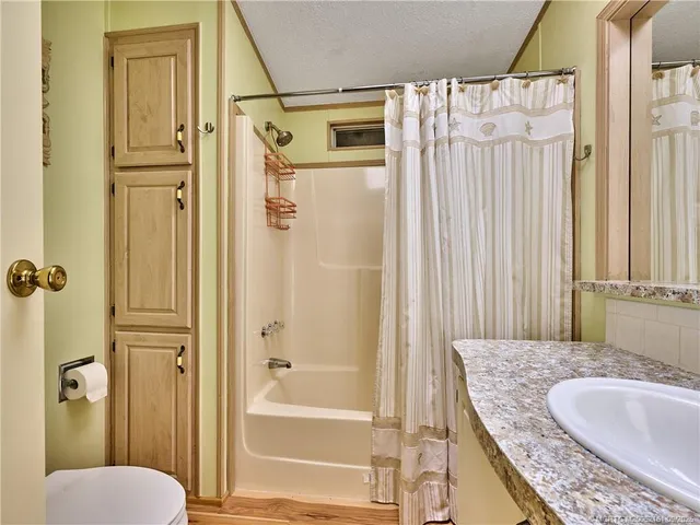 a utility room with wooden floor washer and dryer