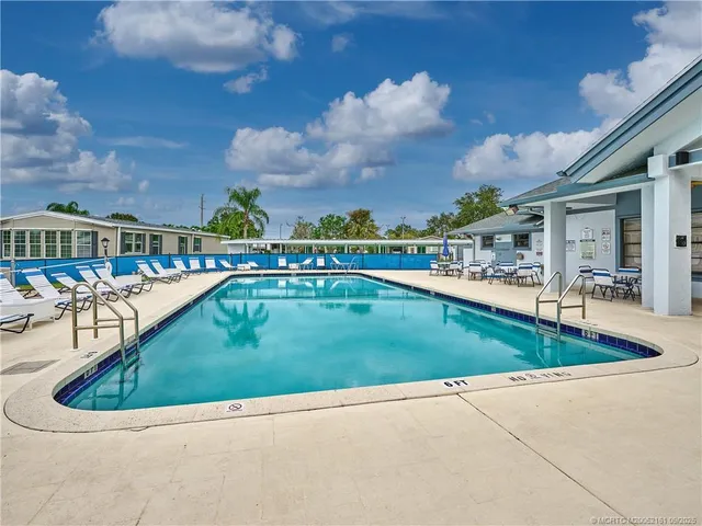 a view of swimming pool with outdoor seating