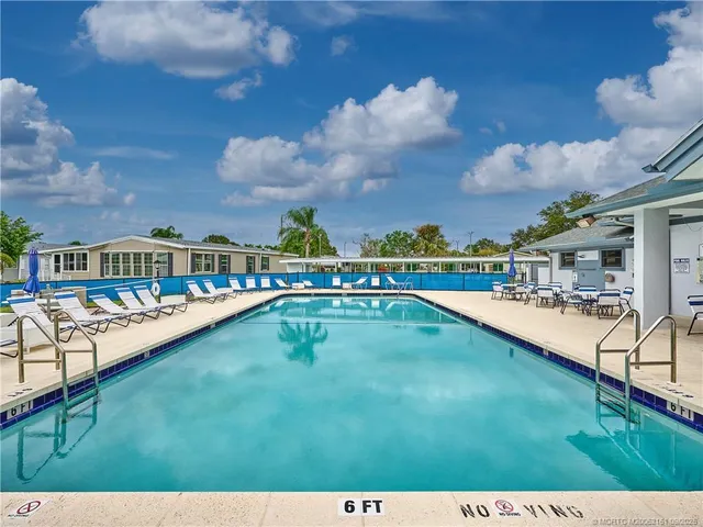 a view of a swimming pool with a table and chairs