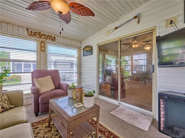 a view of a hallway with dining area and chandelier