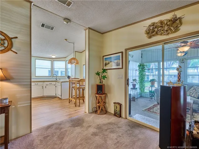 a living room with furniture and kitchen view