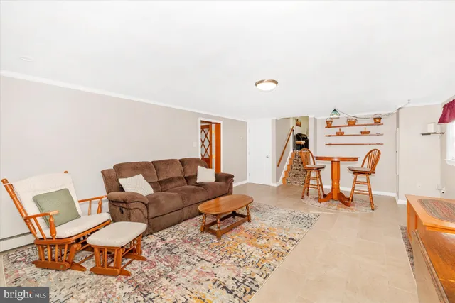 a living room with furniture a rug and a lamp
