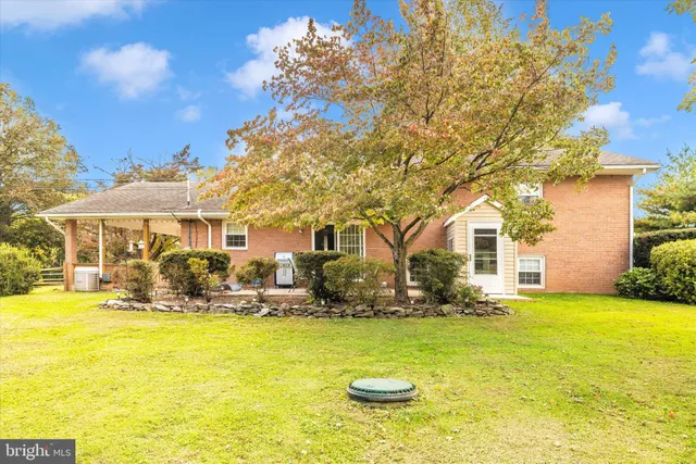 a view of a chair and table in the backyard of the house