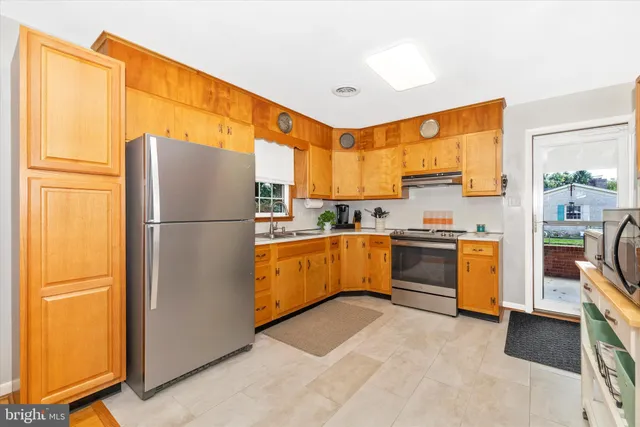 a kitchen with stainless steel appliances a stove and more cabinets