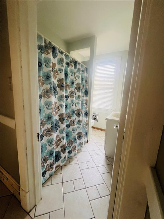 1816 Monroe Street Pittsburgh, PA 15218 - Photo 12 of 21 a bathroom with a glass door shower