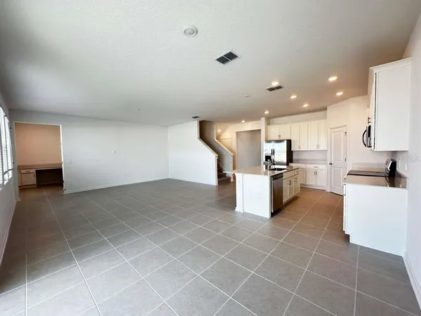 a kitchen with stainless steel appliances a refrigerator sink and stove