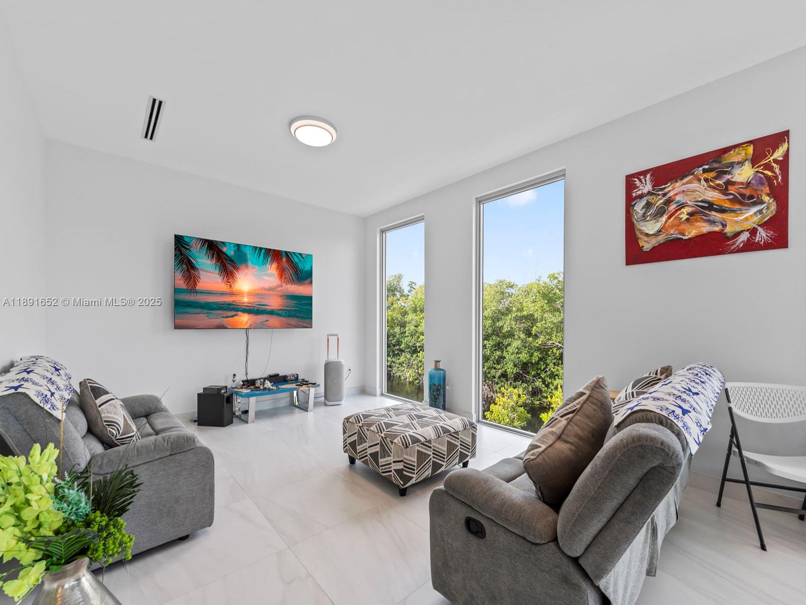 474 Bahia Honda Road Key Largo, FL 33037 - Photo 13 of 33 a living room with furniture and a flat screen tv