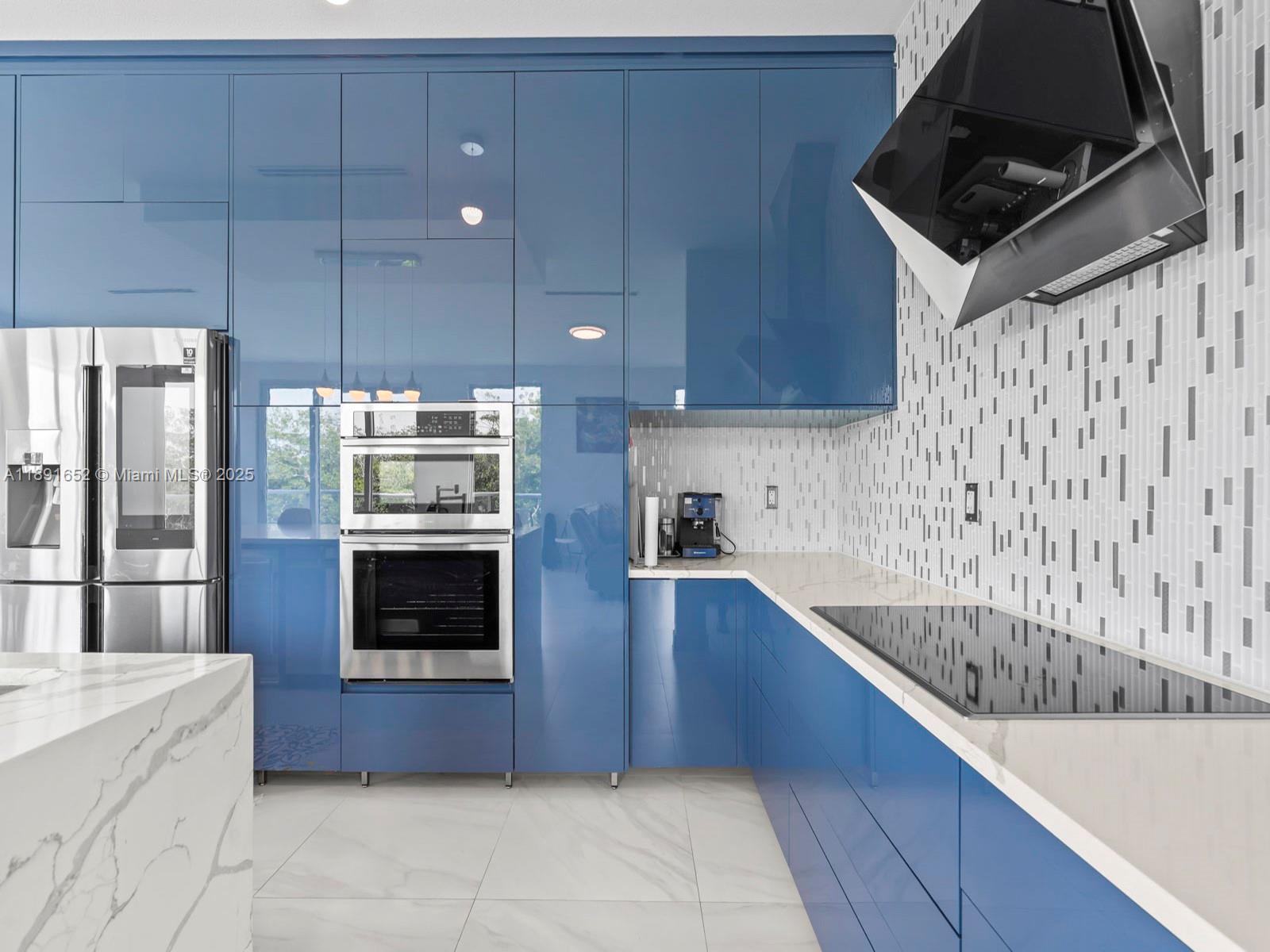 474 Bahia Honda Road Key Largo, FL 33037 - Photo 16 of 33 a kitchen with stainless steel appliances a stove a microwave and a sink