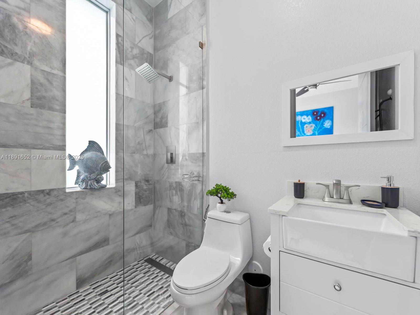 474 Bahia Honda Road Key Largo, FL 33037 - Photo 19 of 33 a bathroom with a toilet sink and shower