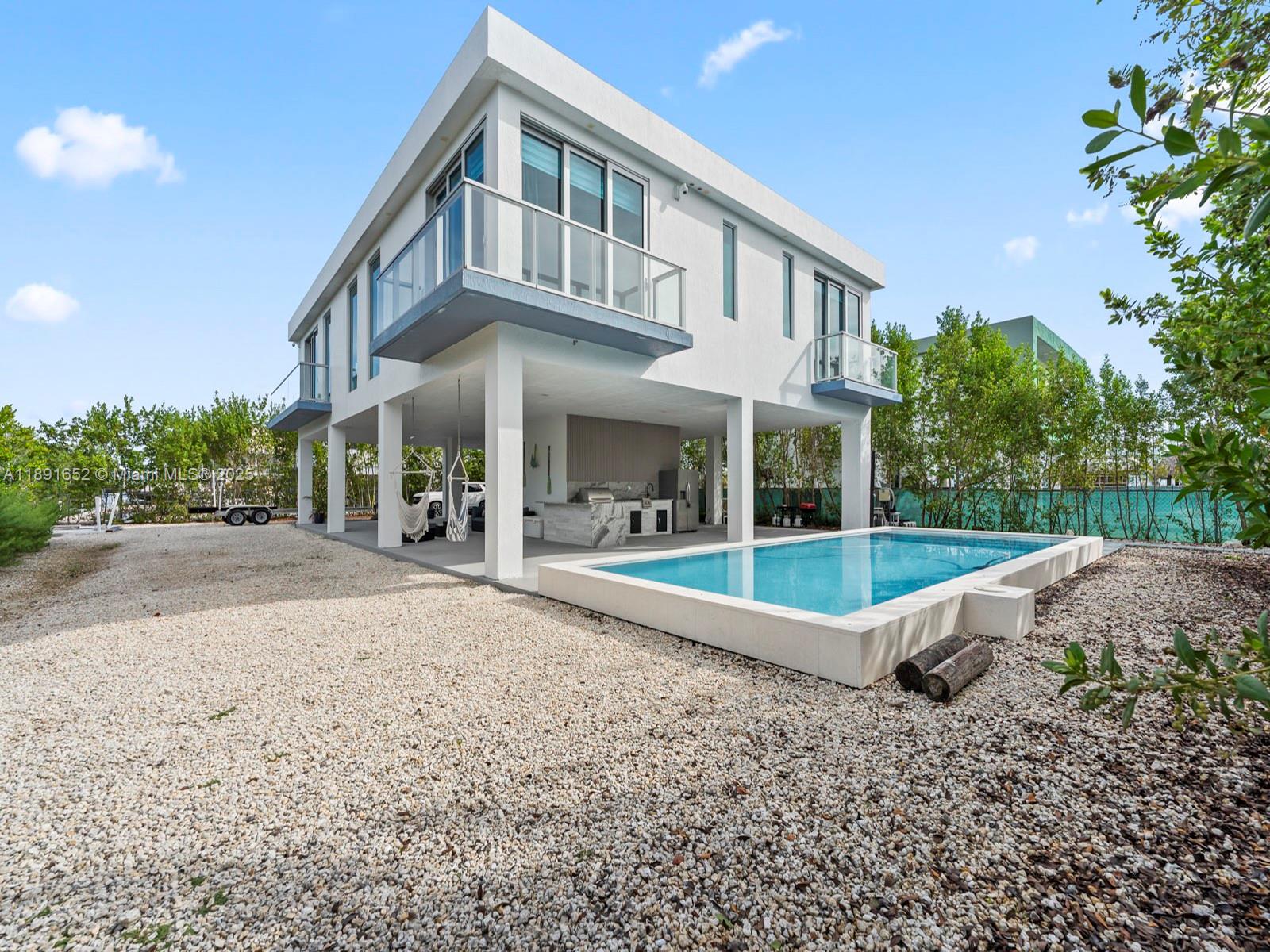474 Bahia Honda Road Key Largo, FL 33037 - Photo 27 of 33 a view of a house with backyard and porch