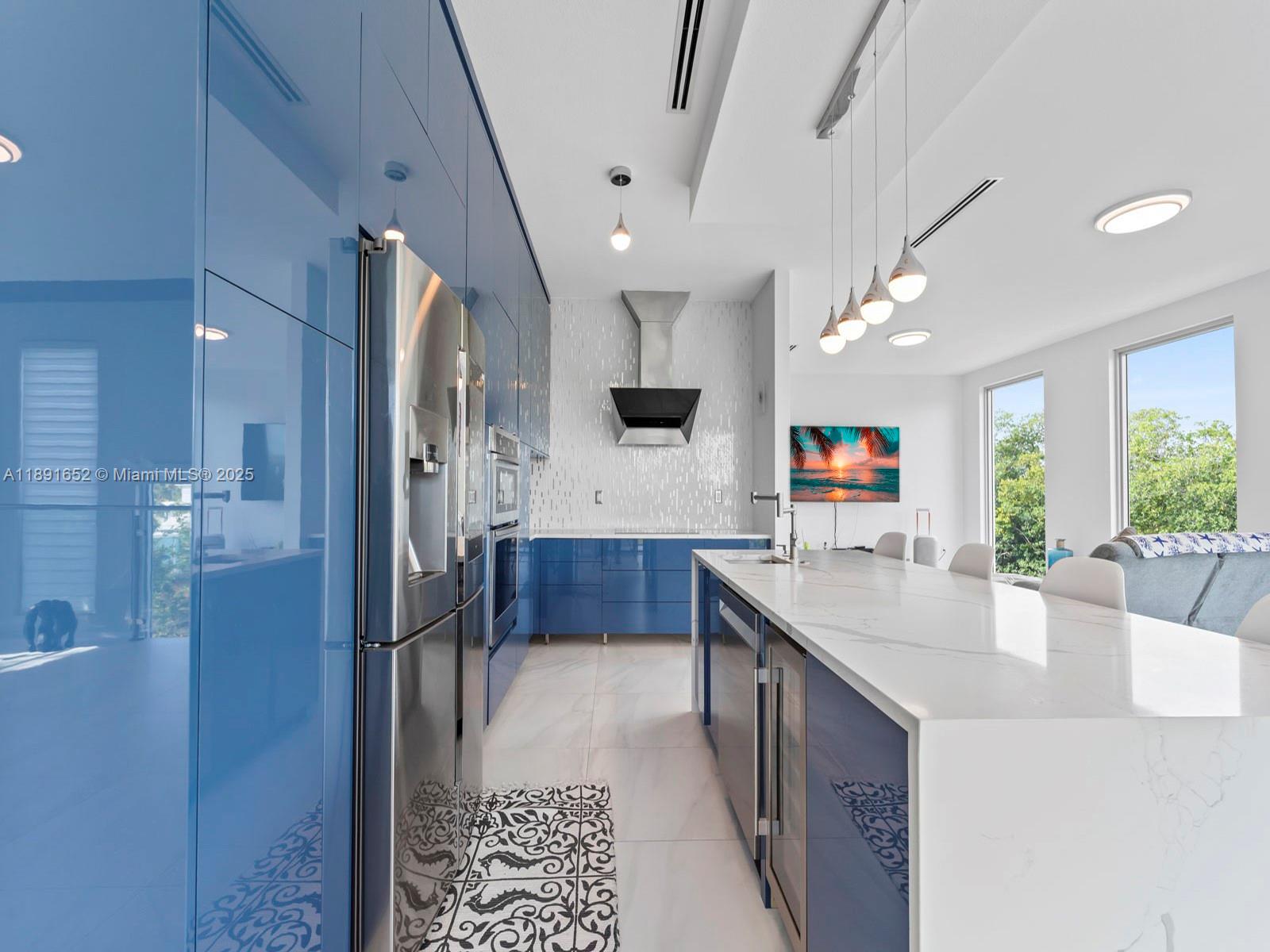 474 Bahia Honda Road Key Largo, FL 33037 - Photo 8 of 33 a kitchen with stainless steel appliances kitchen island granite countertop a refrigerator and a sink