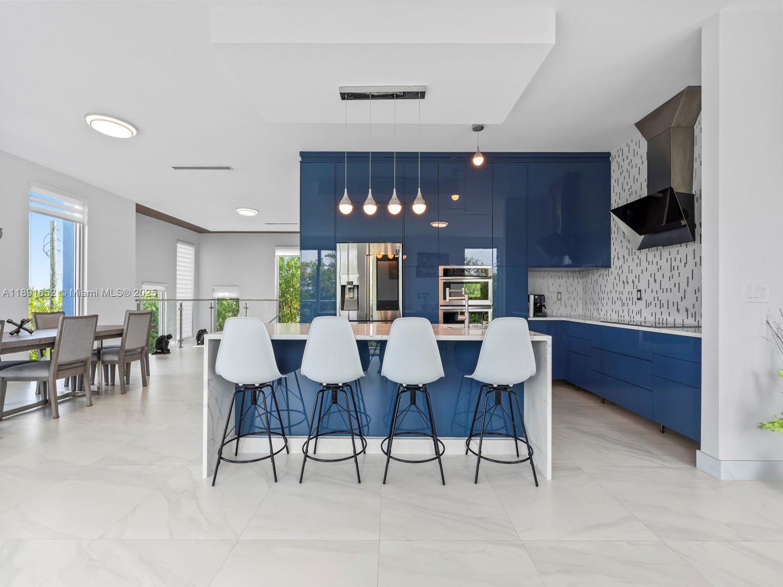 474 Bahia Honda Road Key Largo, FL 33037 - Photo 10 of 33 a large kitchen with a table and chairs