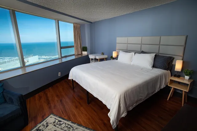 a bed sitting in a bedroom next to a window