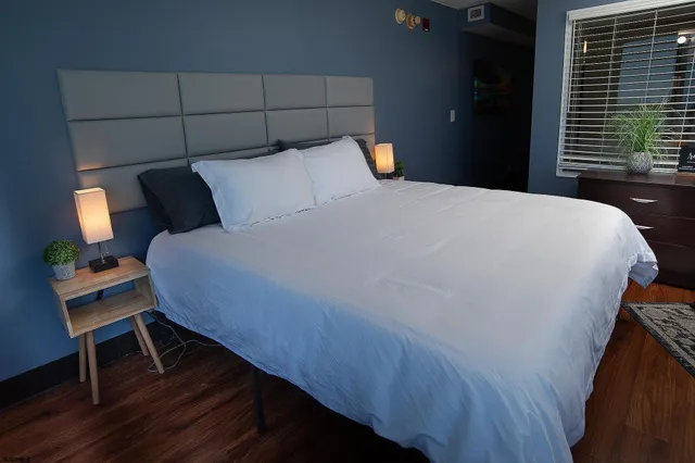 a bed sitting in a bedroom next to a window