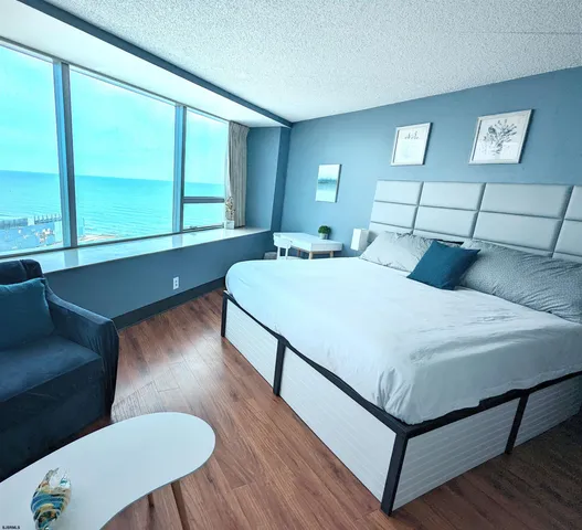 a bedroom with a bed window and wooden floor