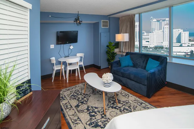a living room with furniture a rug and a flat screen tv