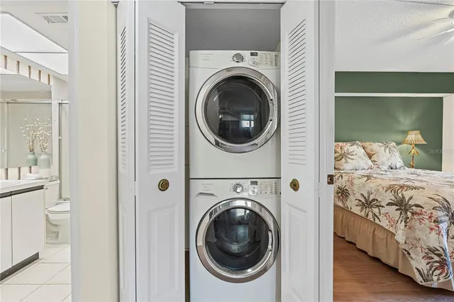a view of a bedroom with washer and dryer