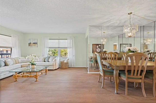 a living room with furniture a table and a chandelier