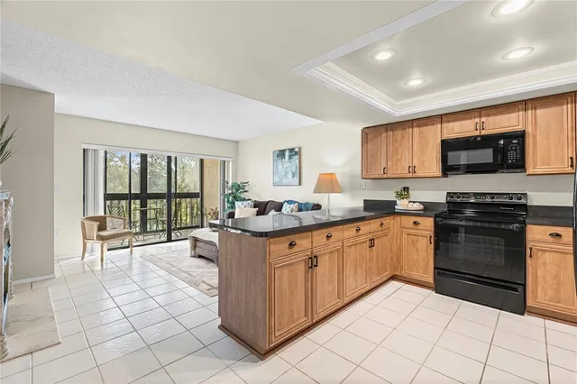 a kitchen with stainless steel appliances granite countertop a stove top oven a sink a counter top space and cabinets