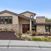 a front view of a house with a yard outdoor seating and garage