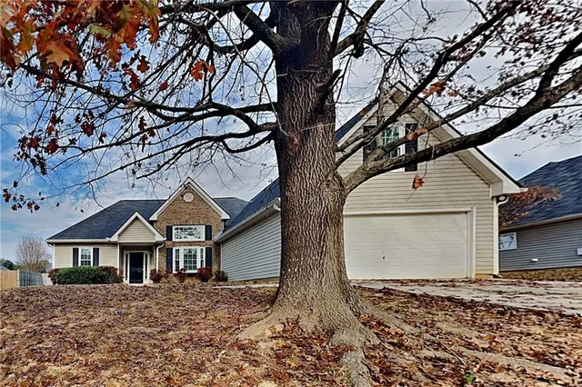 a house that has a tree in front of it