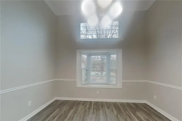 a view of a livingroom with wooden floor and staircase
