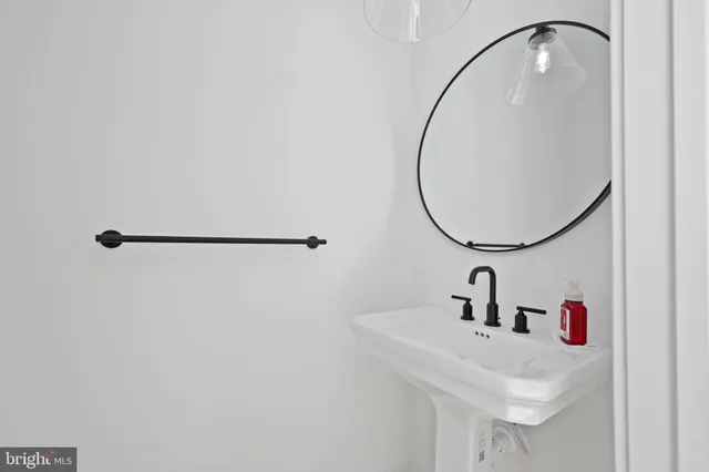 a bathroom with double vanity sink and a mirror